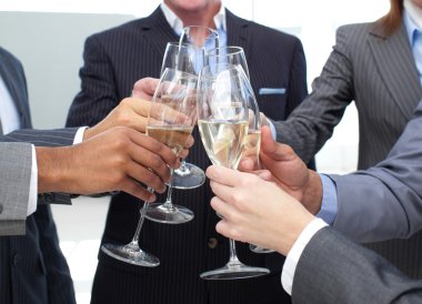 Close-up of business team toasting with Champagne clipart