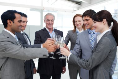 Cheerful business team toasting with Champagne clipart