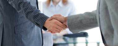 Close-up of businessmen shaking hands clipart