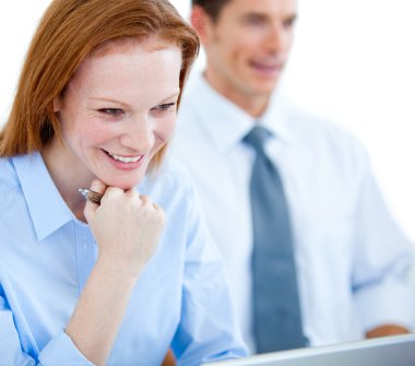 Portrait of a happy businesswoman at her desk clipart