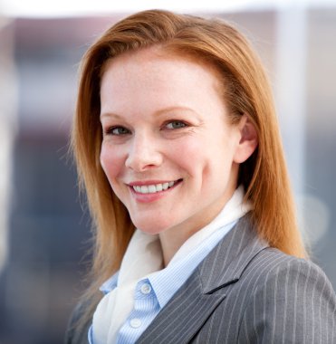 Confident business woman looking at the camera clipart