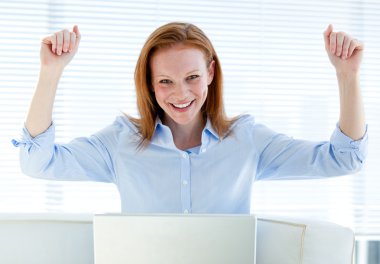 Bright business woman punching the air clipart