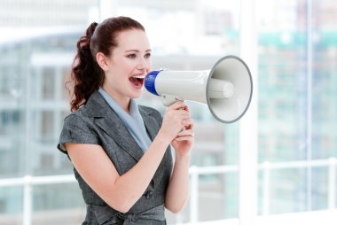 Self-assured businesswoman yelling through a megaphone clipart