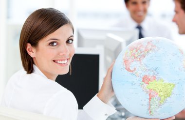 Smilling businesswoman holding a globe clipart