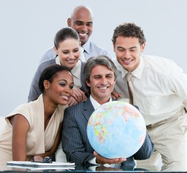 United businessteam holding a globe globalization concept clipart