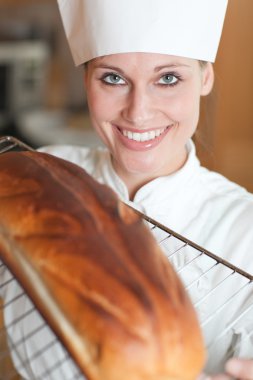 Smiling female chef baking bread clipart