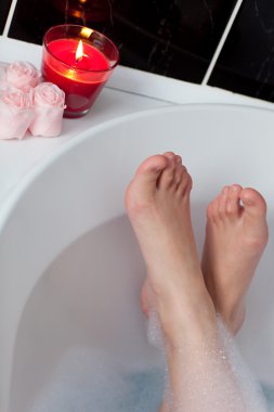 Close-up of woman's feet in a bath clipart