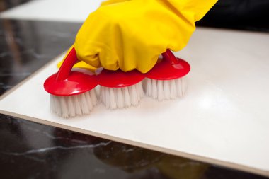 Close-up of a person cleaning a bathroom's floor clipart