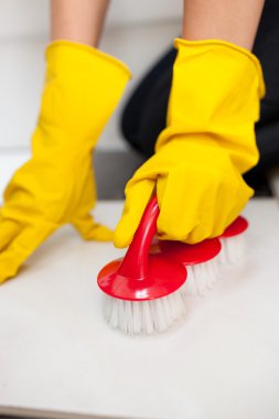 Close-up of a woman cleaning a bathroom's floor clipart