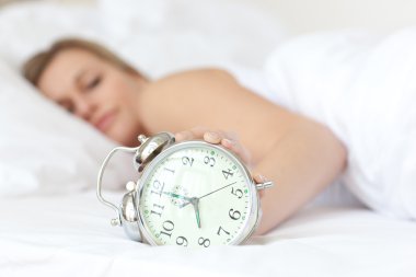 Young woman holding an alarm clock clipart
