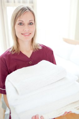 Positive cleaning lady holding towels clipart