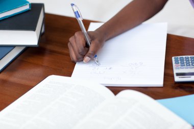 Close-up of an Afro-American girl doing her homework clipart