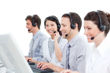 A diverse group of customer service agents working in a call cen clipart