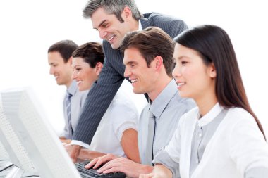 Young businesspeople and their manager working hard at computers clipart