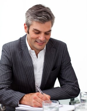 Assertive mature businessman studying a document clipart