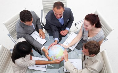 High angle of business holding the world clipart