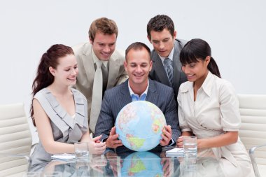 Business team holding the world. Global expansion clipart