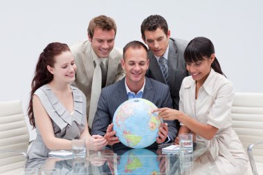 Business team holding a terrestrial globe clipart