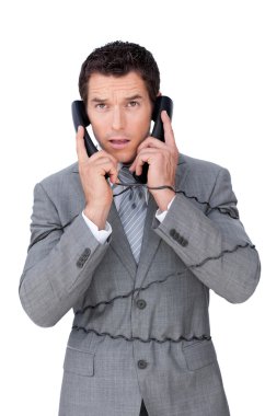 Stressed businessman tangle up in telephone wires clipart