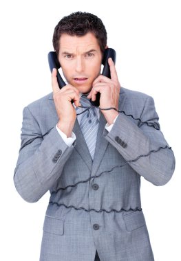 Angry businessman tangle up in phone wires clipart