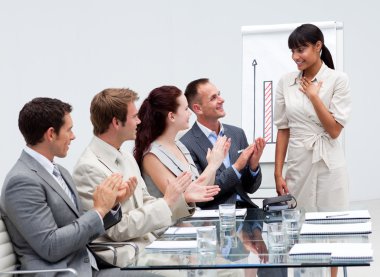 Business team applauding a colleague after giving a presentation clipart