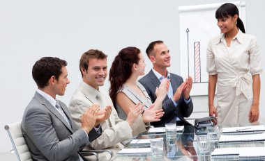 Businessman applauding a colleague after giving a presentation clipart