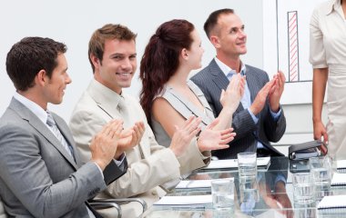 Business applauding a colleague after giving a presentati clipart