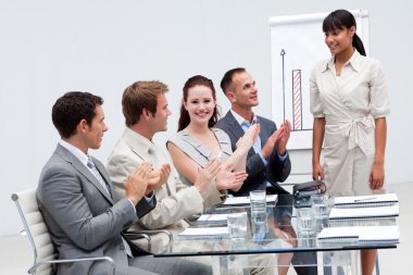 Businesswoman applauding a colleague after giving a presentation clipart