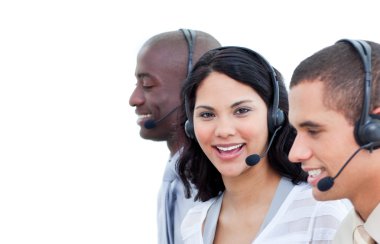 Portrait of a brunette woman and her team working in a call cent clipart