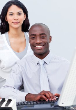 Brunette businesswoman and her colleague working at a computer clipart