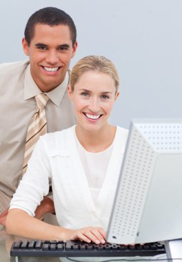 Two colleagues working at a computer clipart