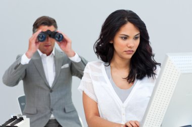 Ambitious businessman looking her colleague's computer through b clipart