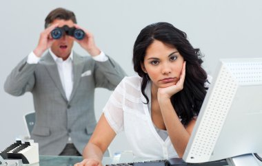 Brunette businesswoman annoyed by a man looking through binocula clipart