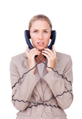 Stressed businesswoman trangled up in telephone wires clipart