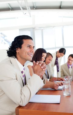 Portrait of a businessman and his team during a presentation clipart