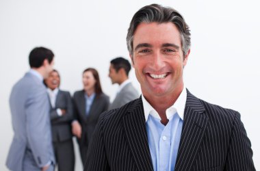 Smiling businessman leading her team clipart