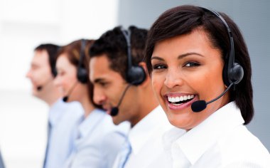 Attractive young woman working in a call center clipart