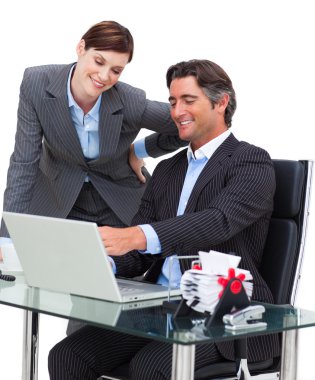 Assertive businessman showing something on computer to his colle clipart