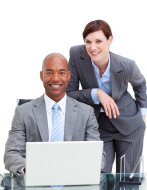 Charming manager assisting her colleague at a computer clipart