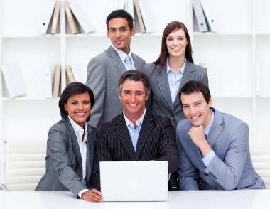 Successful business team looking at a laptop clipart