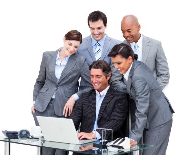 Cheerful international business team looking at a laptop clipart