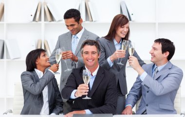 Cheerful business toasting with Champagne clipart