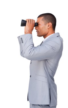 Confident businessman using binoculars clipart