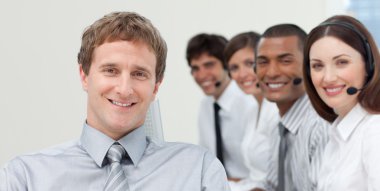 Manager and his team smiling at the camera clipart