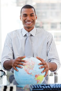 Enthusiastic businessman showing a terrestrial globe clipart