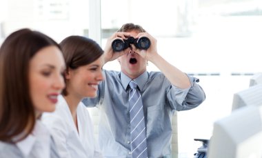 Charismatic businessman looking through binoculars clipart