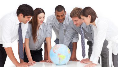 A meeting of business team around a terrestrial globe clipart