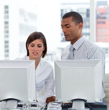 Two business helping each other with their computers clipart