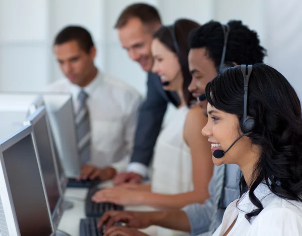 Businesswoman in a call center with her international team — Stock Photo, Image