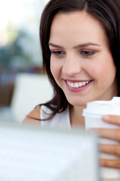 Beautiful businesswoman in office drinking coffee — Stock Photo, Image